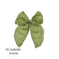 Large Green colored bow with frayed dots on a white background
