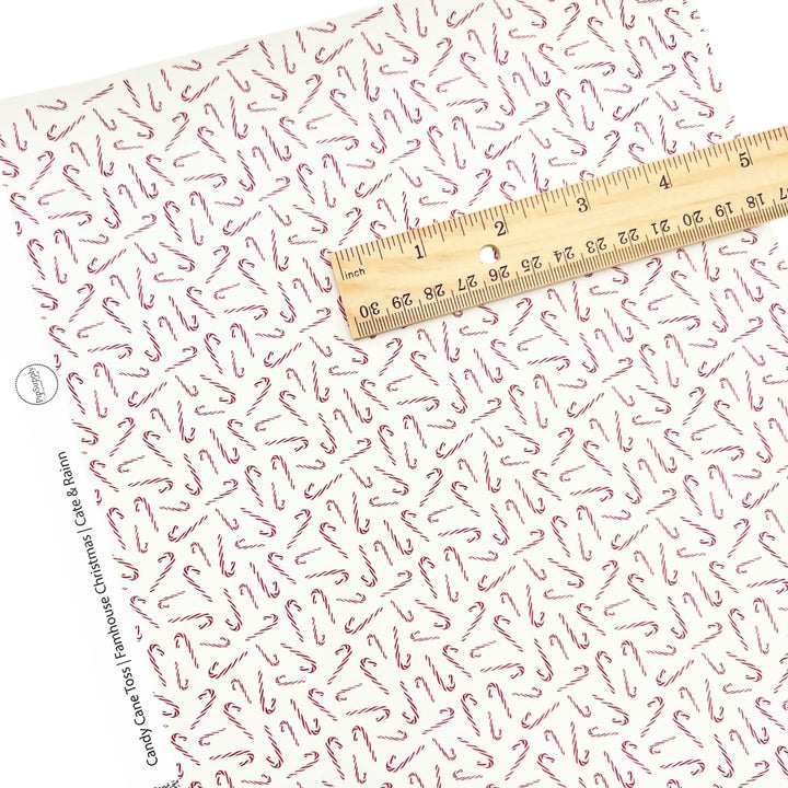 Rolled or individual christmas faux leather sheet with red and white candy canes on a white background