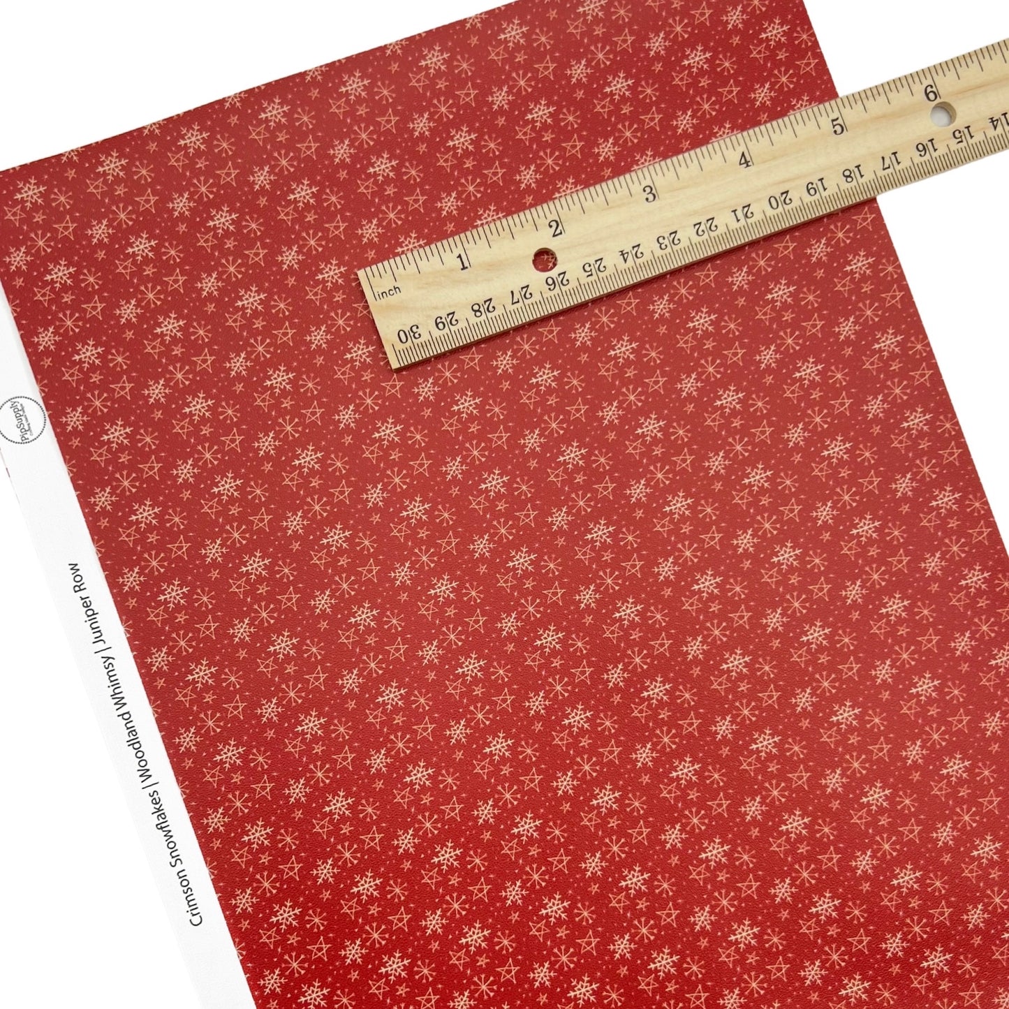 Rolled or individual christmas faux leather sheet with Snowflakes on a red background