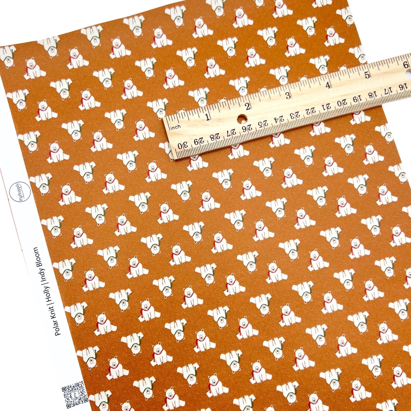 Rolled or individual christmas faux leather sheet with polar bears on an orange background