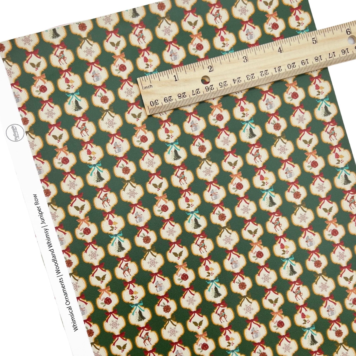 Rolled or individual christmas faux leather sheet with a green background and christmas ornamemts