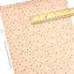 Light pink colored faux leather sheet with neutral colored dots