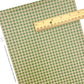 Individual holiday christmas green plaid faux leather sheet with a ruler lying on top