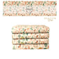 Beige fabric stack with Christmas Trees, Ornaments, Stockings, Candy Canes, and a Candle