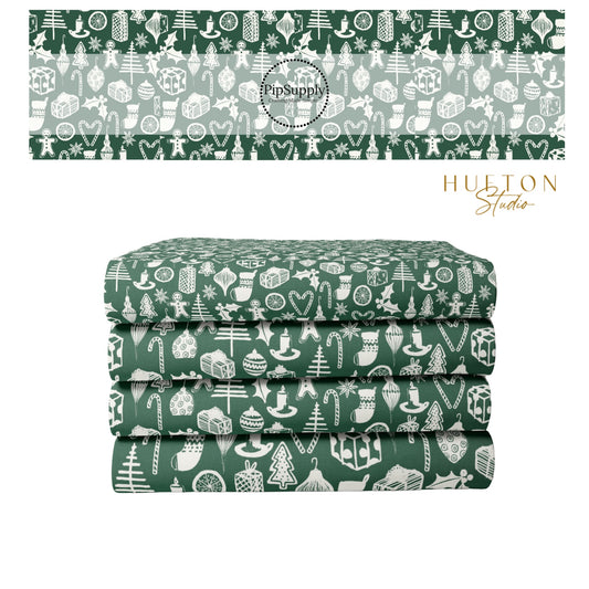 Green fabric stack with white Christmas designs