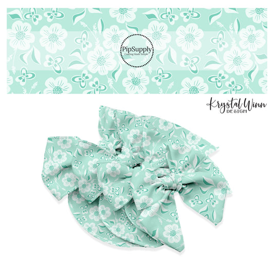 White flowers with white and aqua butterflies on aqua bow strips