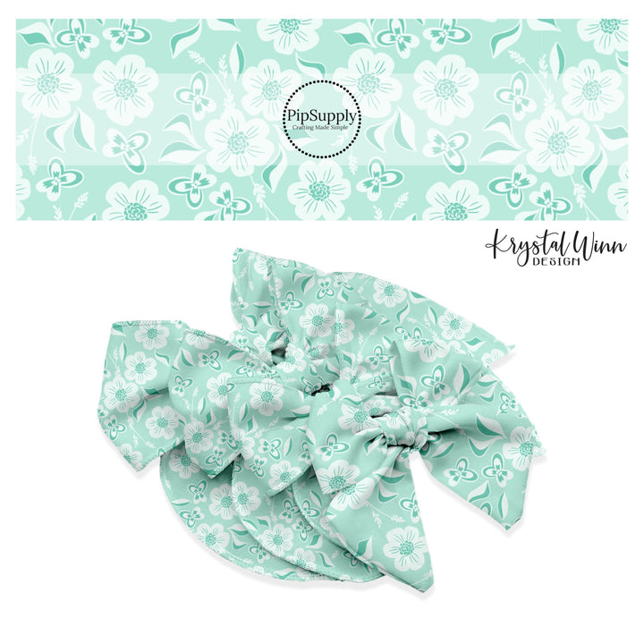 White flowers with white and aqua butterflies on aqua bow strips