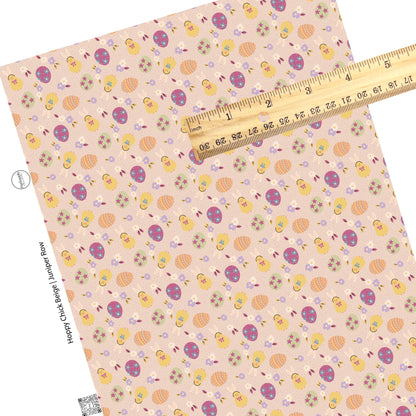 Yellow chick with bunny ears, flowers, and green, purple, and orange patterned easter eggs on blush polka dot faux leather sheet