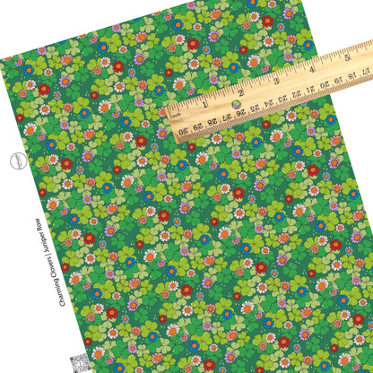 Red, blue, and pink flowers on green clovers with gold stars on a green faux leather sheet