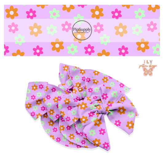 Hot pink, orange, and green flowers on a bright lavender bow strip