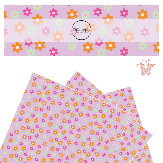 Hot pink with light pink center, orange with white center, and mint with pink center flowers on a lavender faux leather sheets