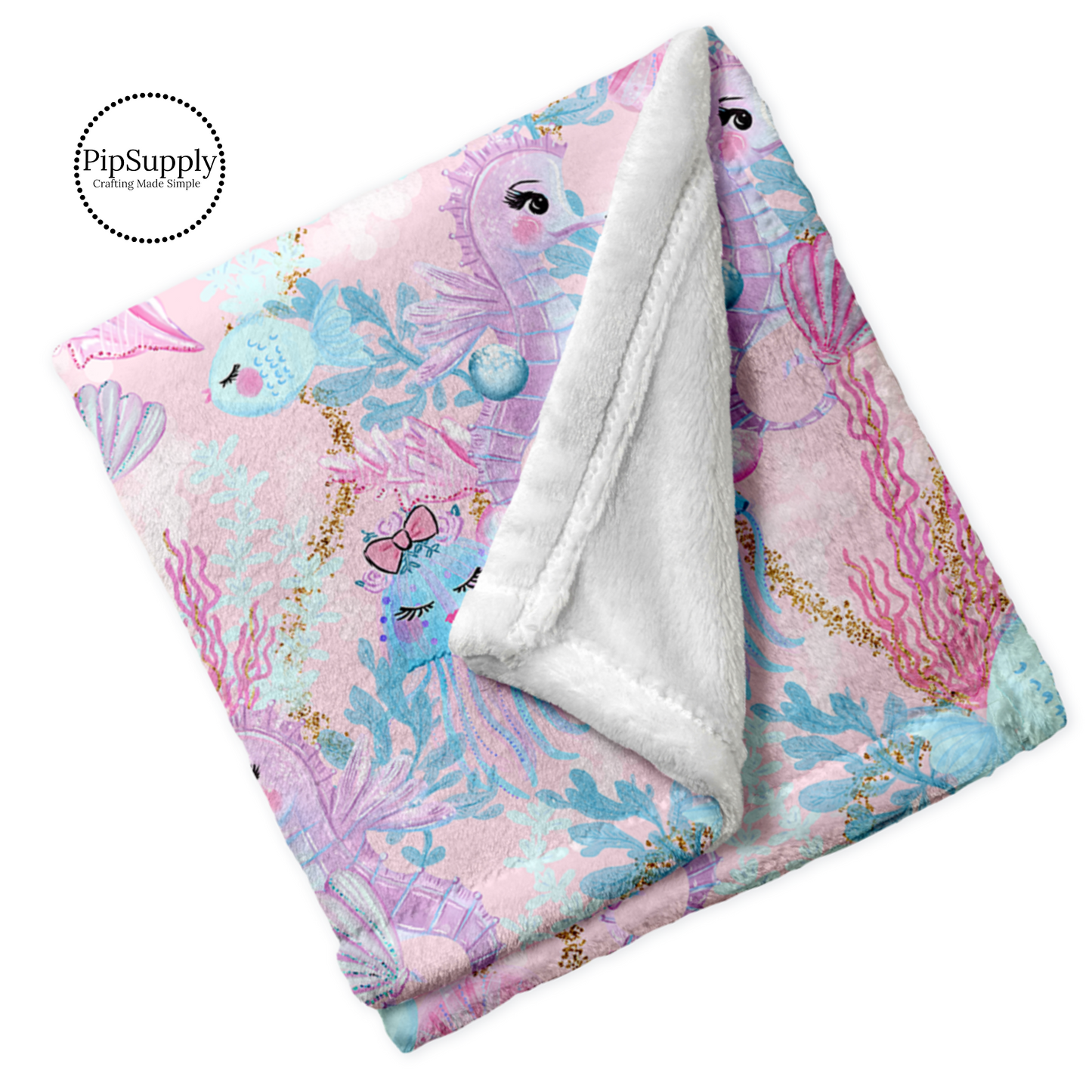 Folded white soft blanket with print of watercolor seahorses, fish, coral, and jelly fish in pink, blue, and purple.