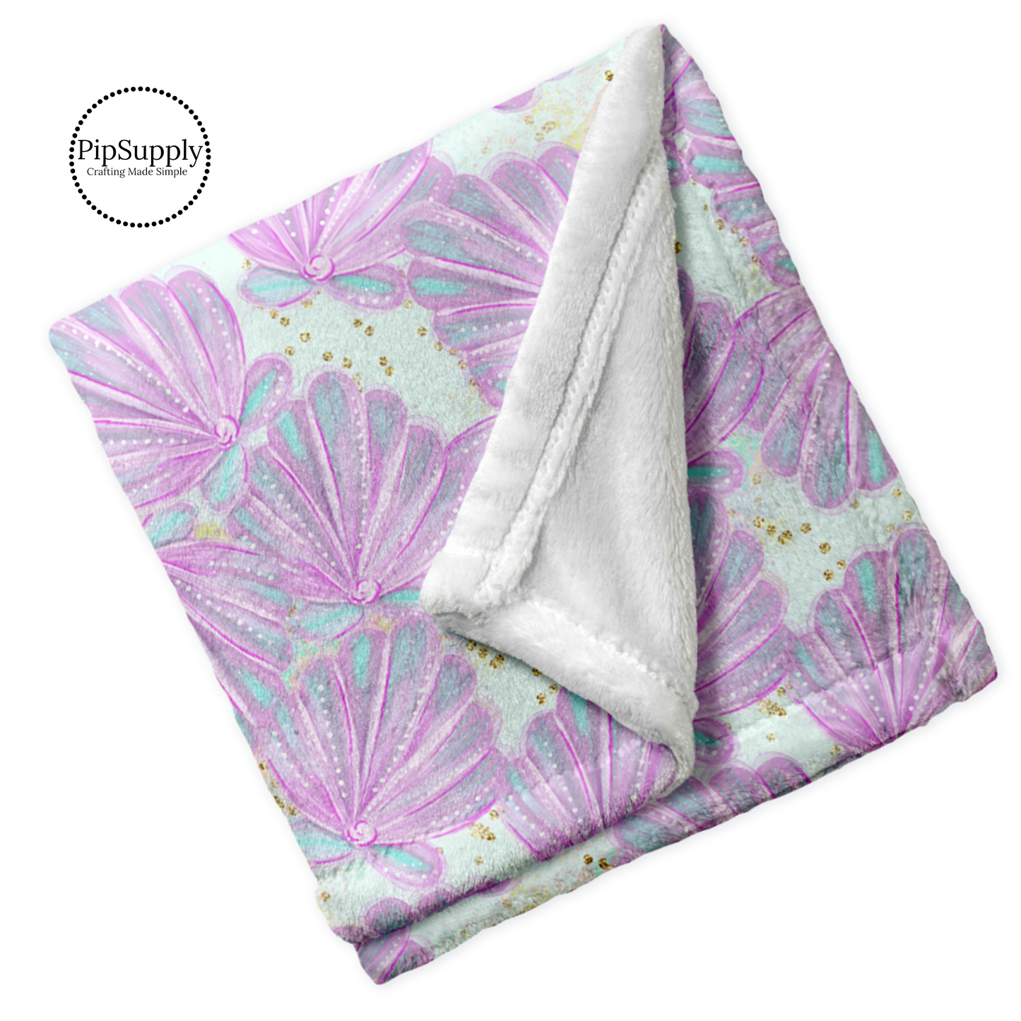 Soft white folded blanket with watercolor lavender, pink, and aqua seashells with gold flecks pattern.