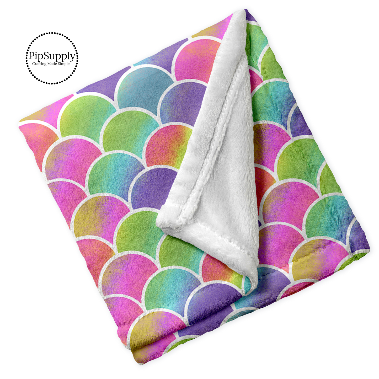 Soft plush folded white minky fur blanket in bright color rainbow scales pattern.