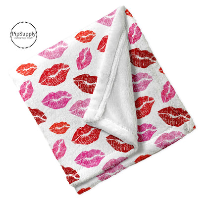 Folded Valentine lipstick kiss patterned minky furry blanket.