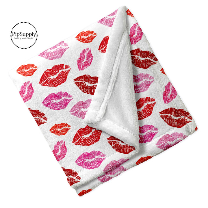 Folded Valentine lipstick kiss patterned minky furry blanket.