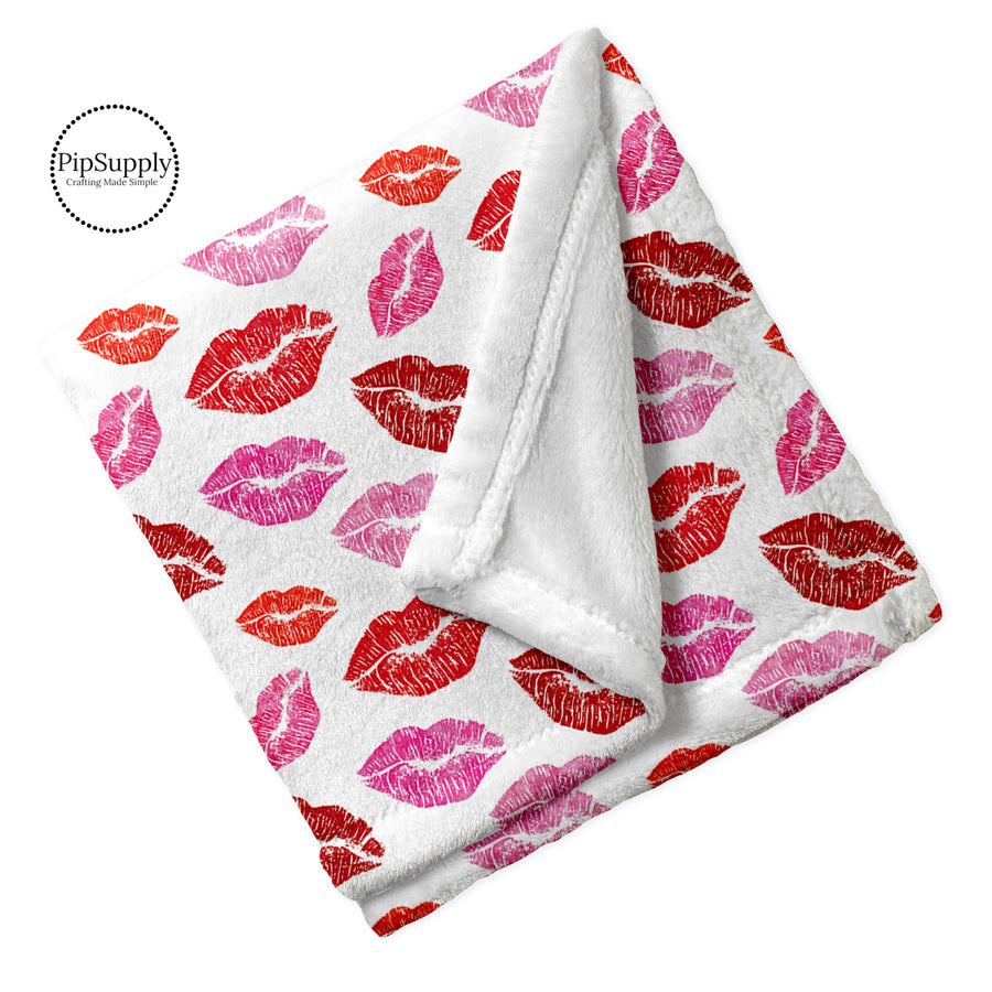 Folded Valentine lipstick kiss patterned minky furry blanket.