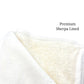 Folded thick fuzzy blanket with inner bottom lining of tick Sherpa furr in base white color.