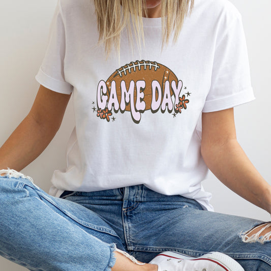 Iron on heat transfer with a football, the phrase "Game day" and flowers.