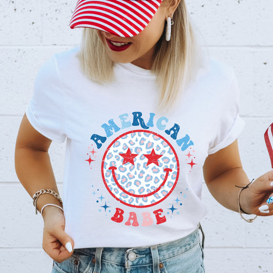 Red, White, and blue leopard print smiley face iron on heat transfer with the phrase "American Babe"