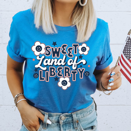 Red, white, and blue daisies and stars with the phrase "Sweet Land of Liberty" iron on heat transfer.