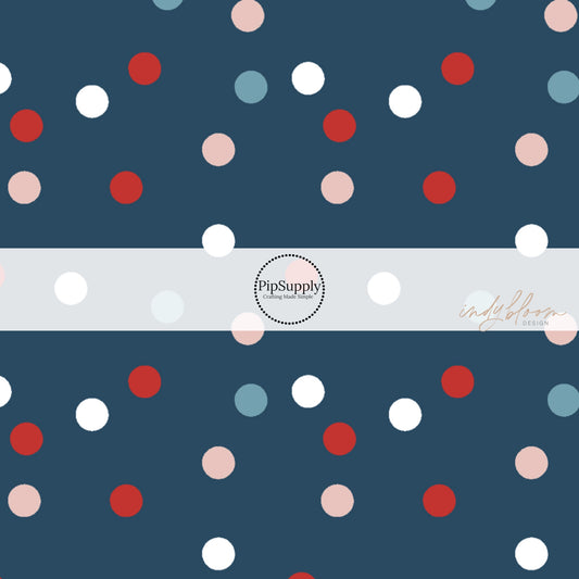 Navy blue fabric by the yard with muted pink, red, white, and light blue polka dots.