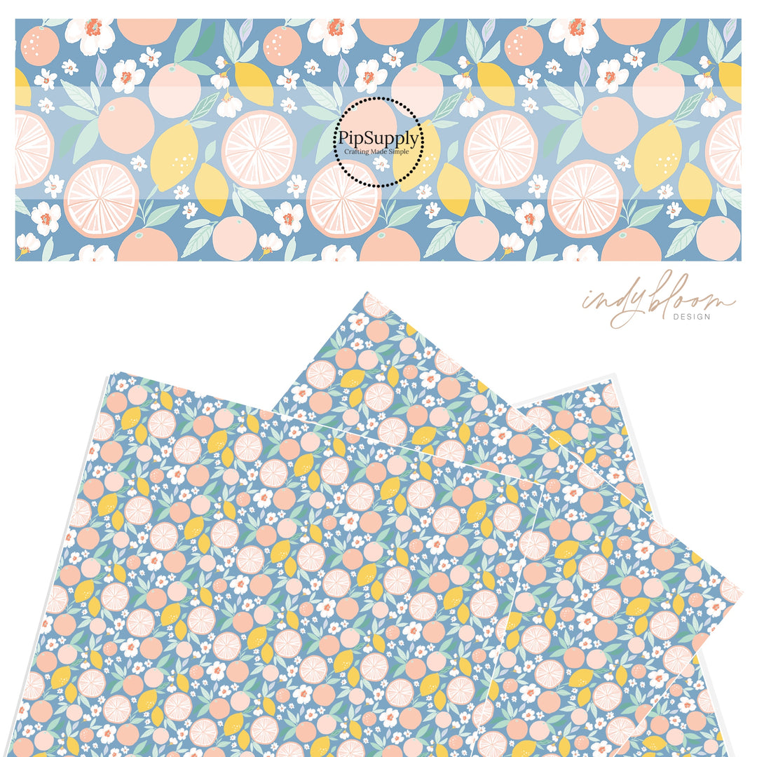 Lemons and grapefruit mix on a pastel blue faux leather sheet.