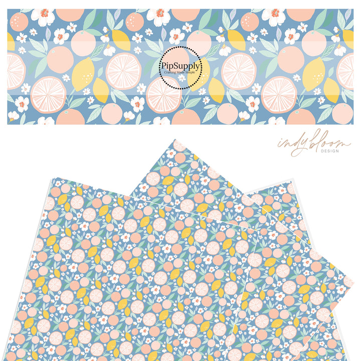 Lemons and grapefruit mix on a pastel blue faux leather sheet.