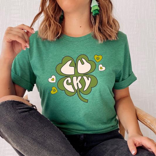Green four leaf clover iron on transfer with the phrase "Lucky" in a white print with white and green hearts