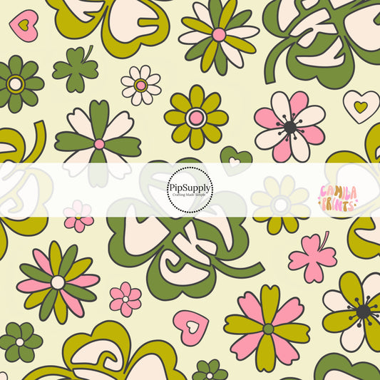 Green St. Patrick's day fabric by the yard with four leaf clovers that say the phrase "Lucky" with flowers and hearts