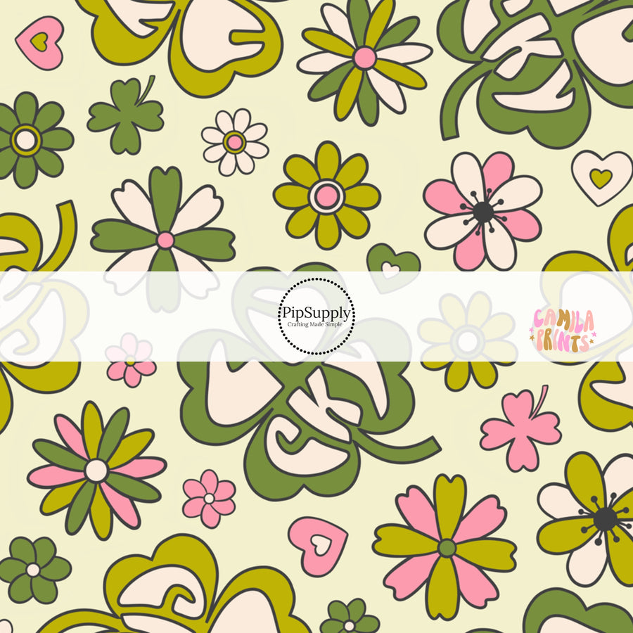 Green St. Patrick's day fabric by the yard with four leaf clovers that say the phrase "Lucky" with flowers and hearts