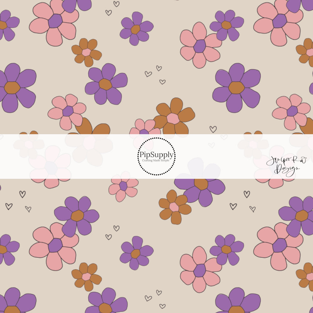 Purple, pink, and orange disperse flowers with tiny black hearts on cream