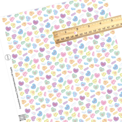 Scattered heart candy on white faux leather sheets