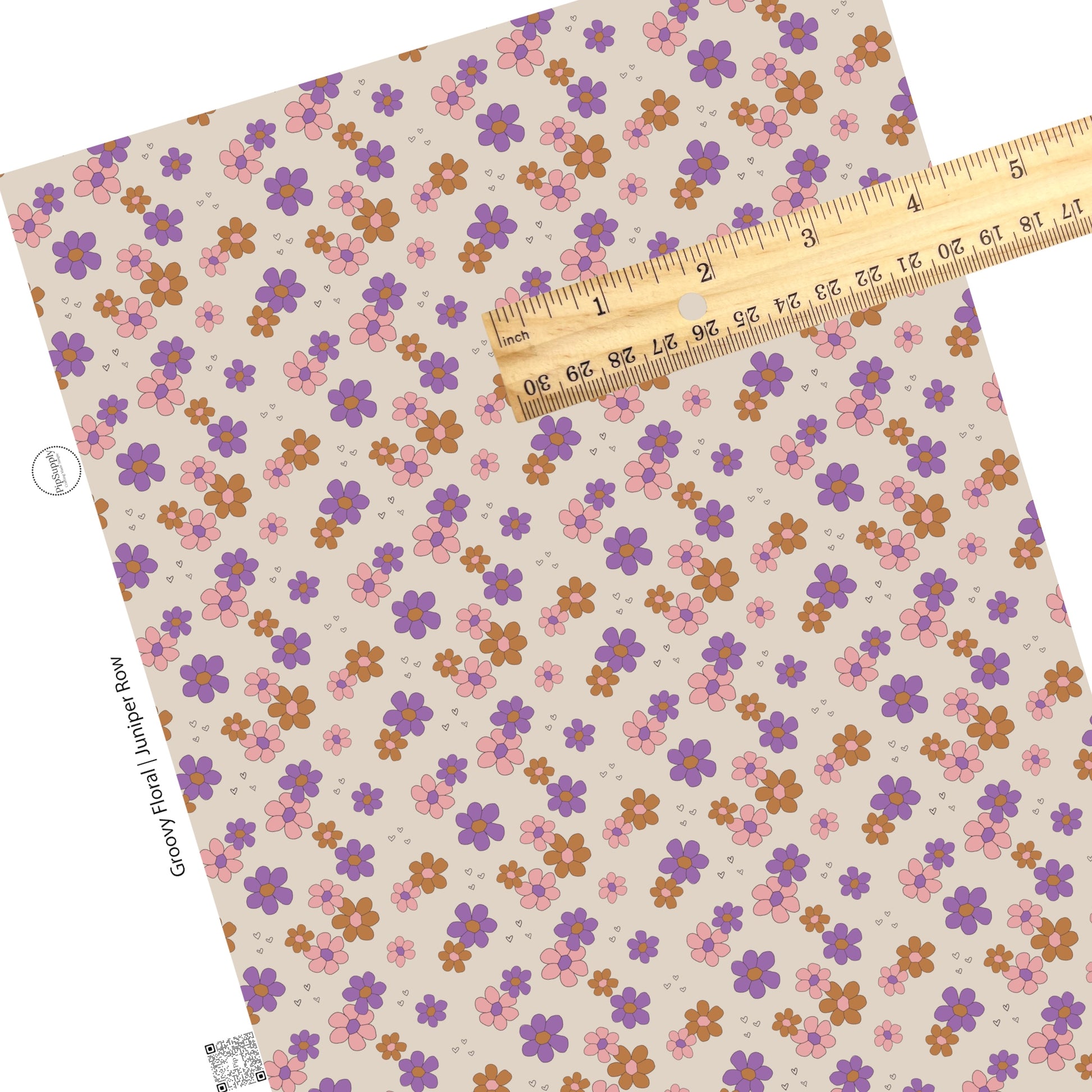 Purple, pink, and rust flowers with tiny black hearts on cream faux leather sheet