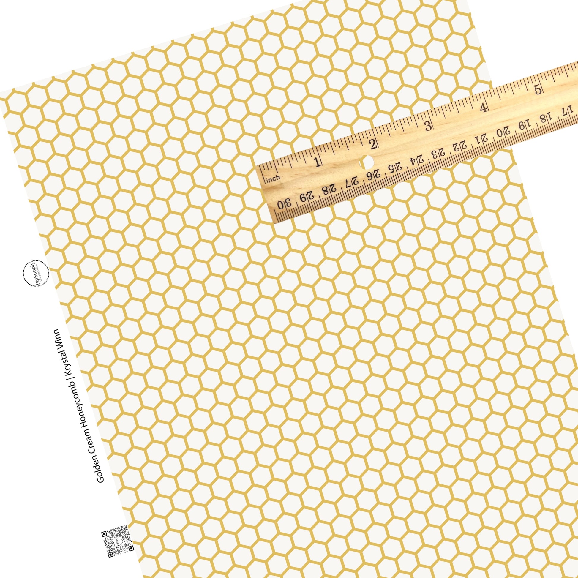 Repeating gold hexagon pattern on a cream faux leather sheet