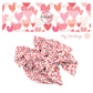 Hot pink, pink, coral, and cream hearts overlapping each other on white bow strips