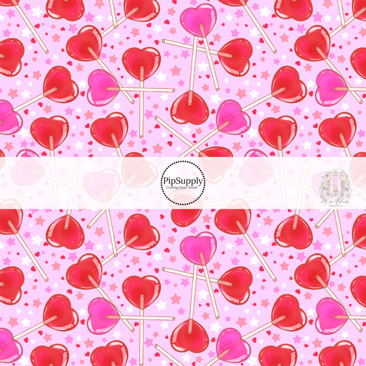 Red and pink heart candy with red hearts and white and pink stars on a light pink bow strip