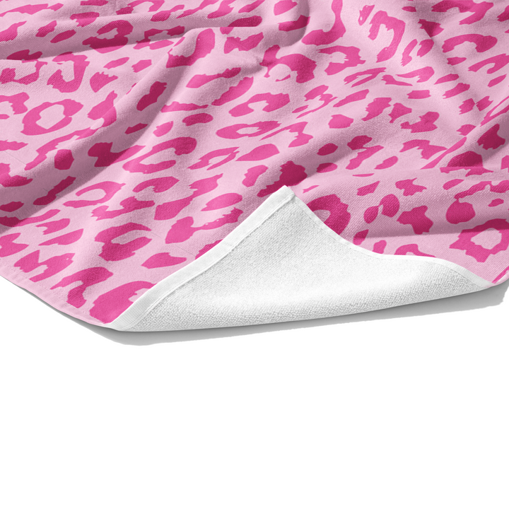 Plush white cotton towel with hot pink and light pink leopard animal print on the front.