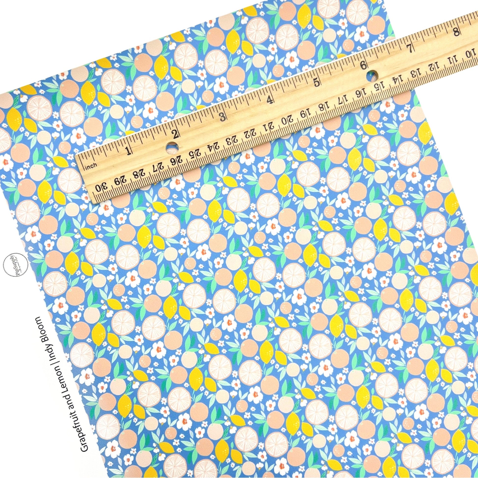 Bittersweet grapefruits and lemons with white flower pattern faux leather sheet.