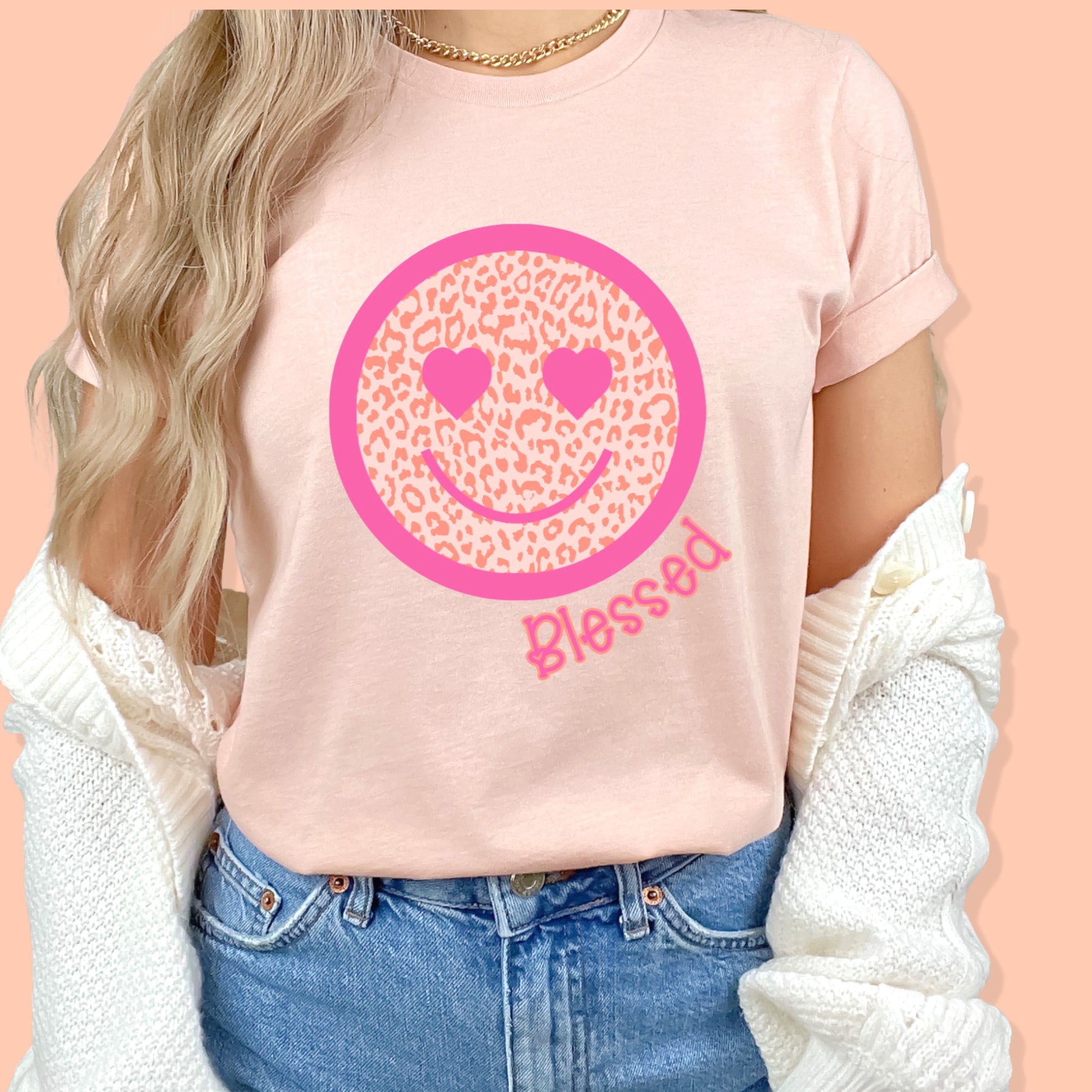 Peach colored smiley face with a pink border and heart eyes, as well as the word "blessed"