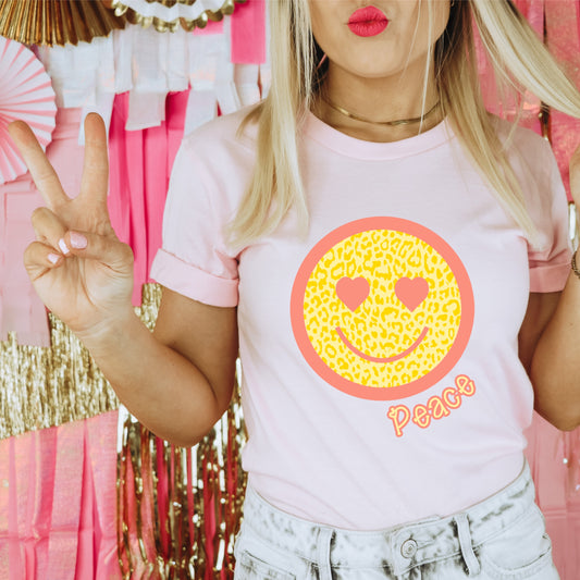Yellow Leopard print smiley face with a pink border and heart eyes. Includes the word "Peace"