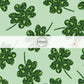 Green Fabric with dark green leopard print shamrocks fabric by the yard