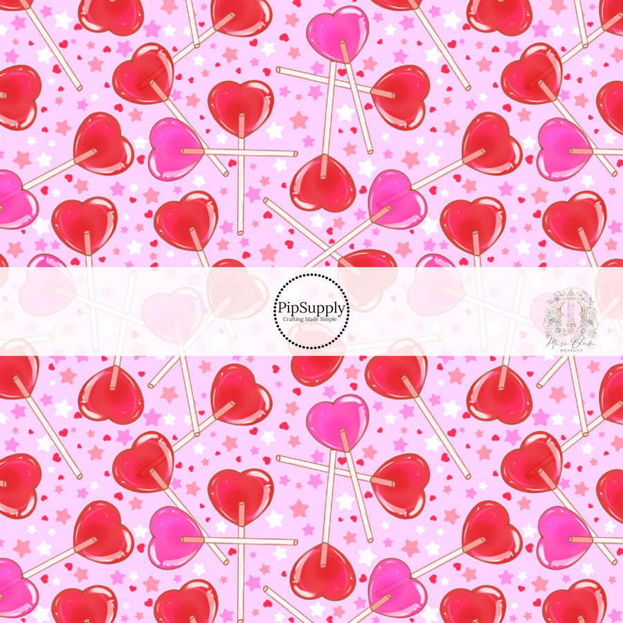 Light pink fabric by the yard with heart shaped lollipops, stars, and hearts