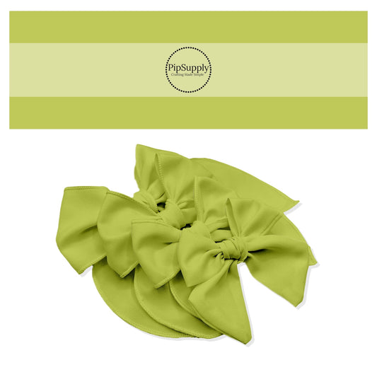 Tied spring Easter solid color hair bow strips in light avocado green.
