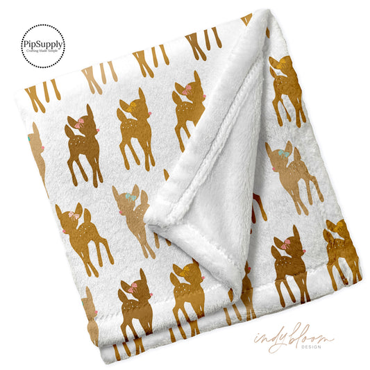 Folded soft minky blanket with reindeer pattern.