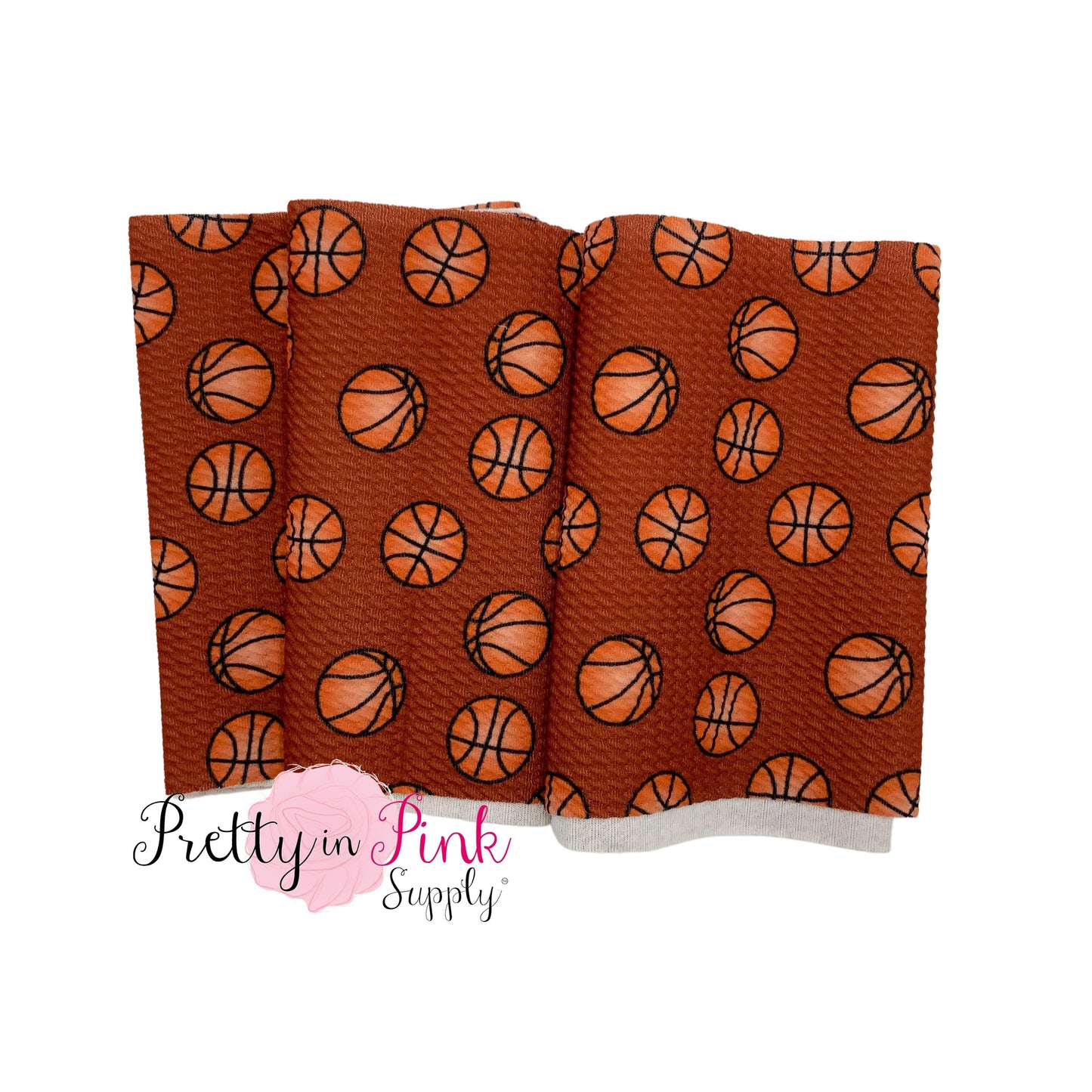 Folded brown liverpool fabric strip with basketballs.