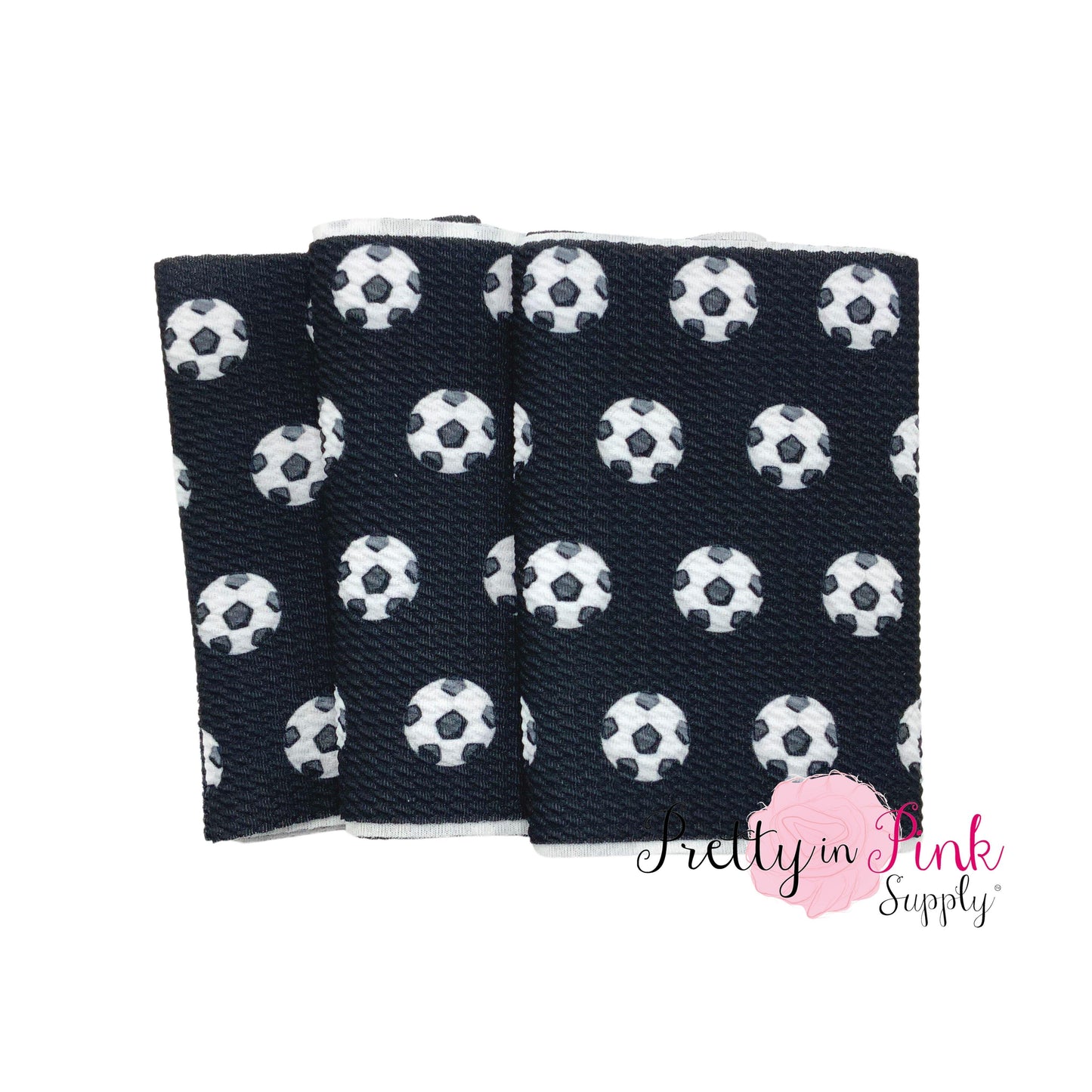 Folded black liverpool fabric strip with soccer balls.