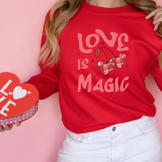 Pink heat transfer with cherries and the phrase "Love is Magic"