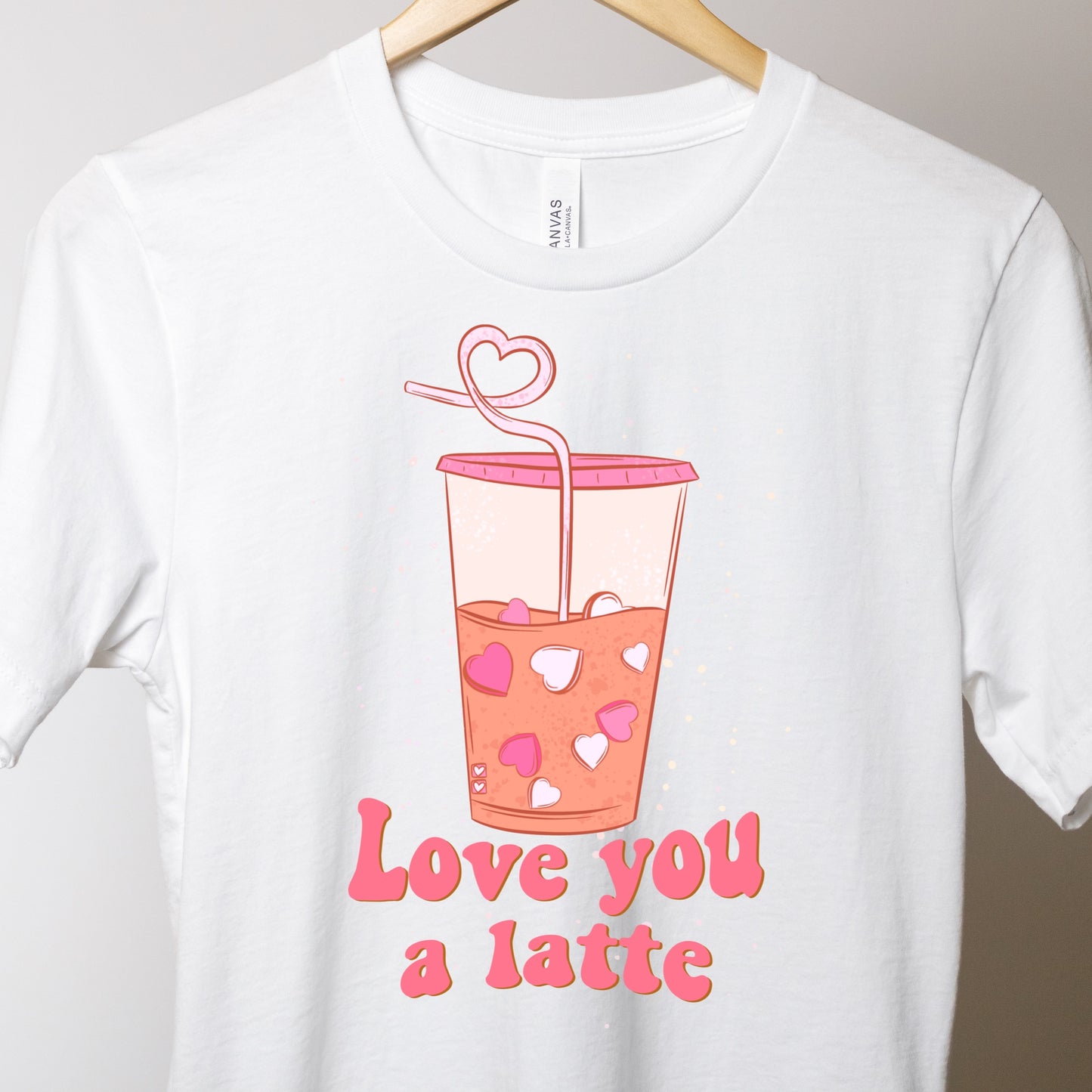 White T-shirt with a valentine's Day themed iron on that says " Love You A Latte"