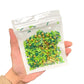 Resealable bag of St. Patrick's Day Clay mix including emerald green polymer clay sprinkles, green shamrock clay slices, and gold beads.